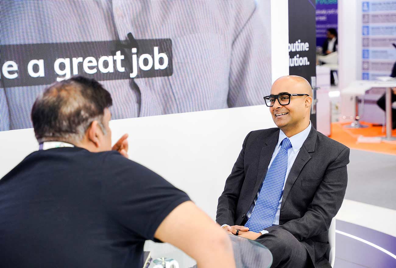 Hexnode's sales executive interacting with attendees at GITEX 2025