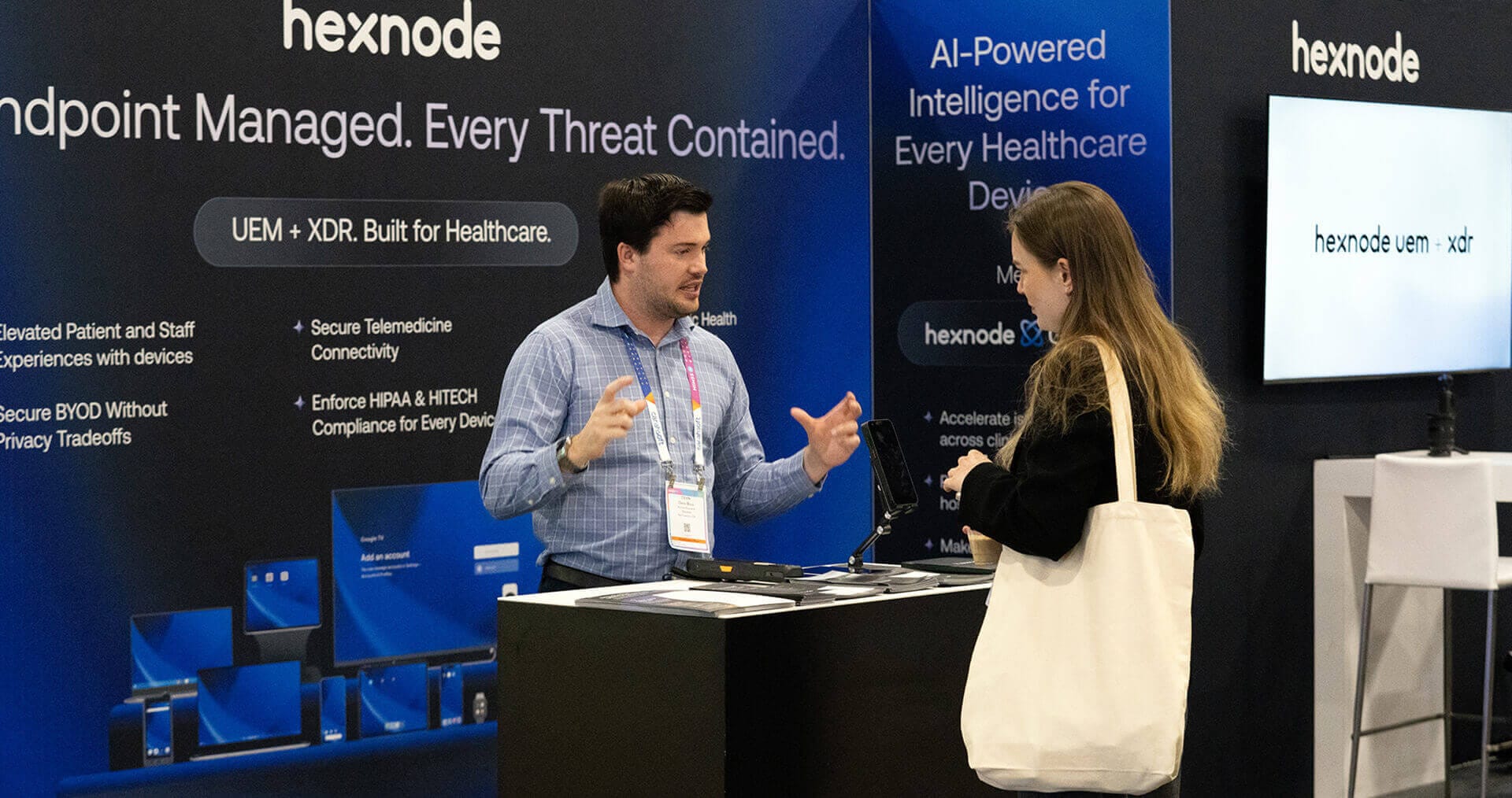 Hexnode sales executive with a customer at HIMSS26