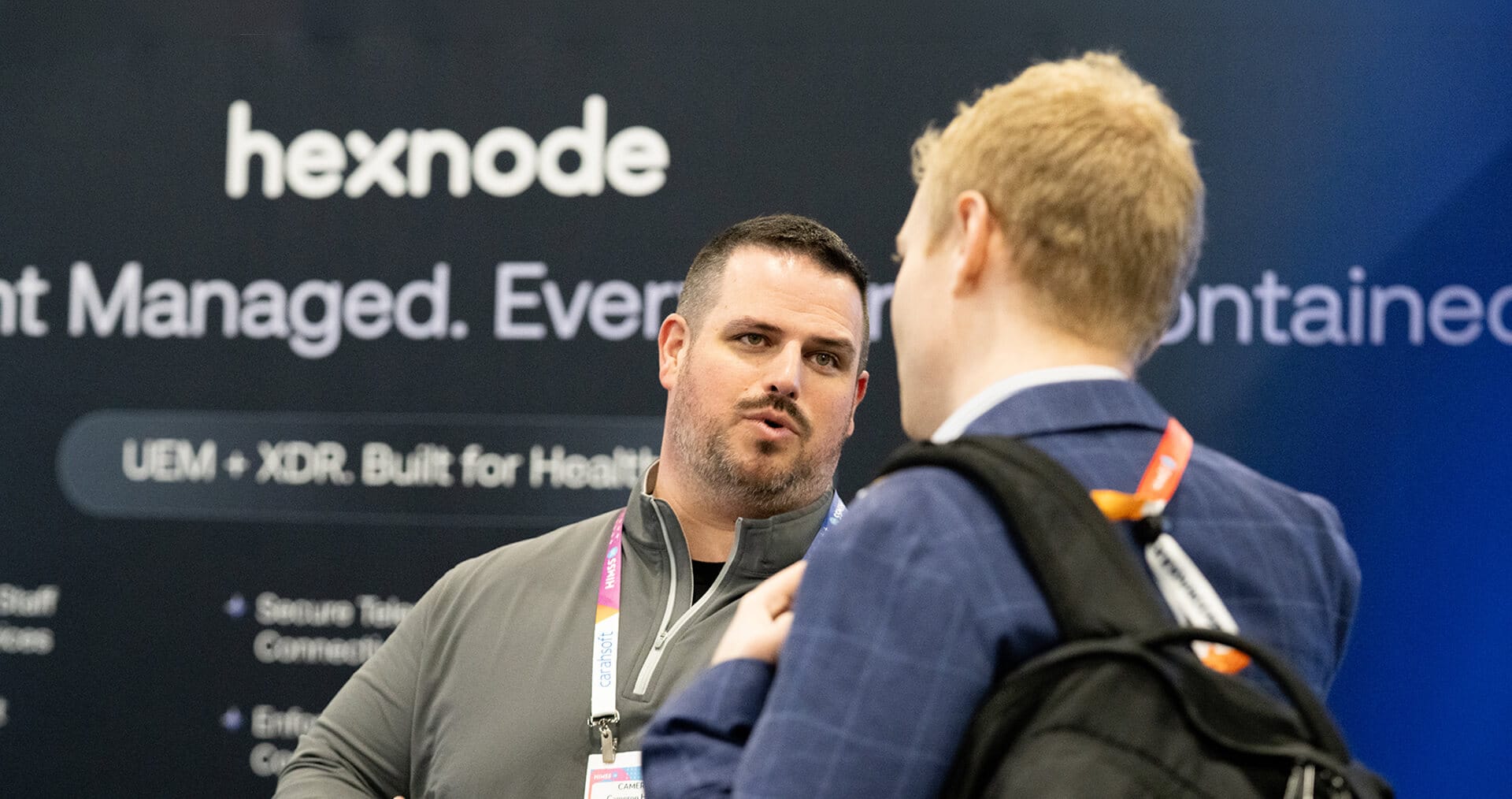 Hexnode sales executive with a customer at HIMSS26